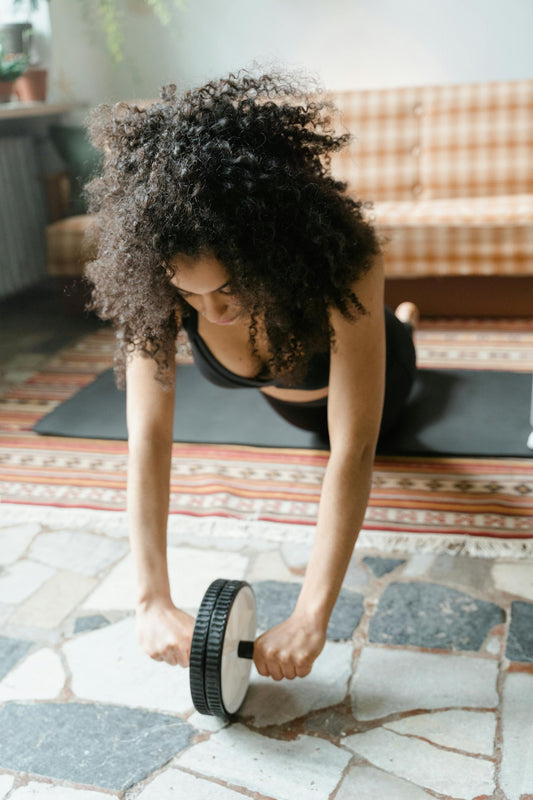 Woman using an ab roller wheel for core strength training at home – fitness equipment for abdominal exercises