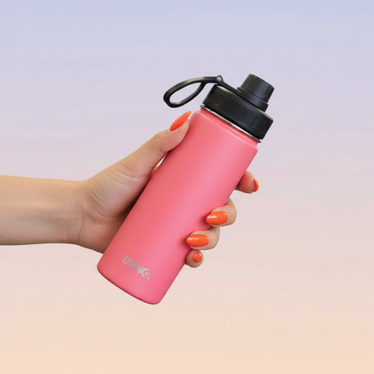 Hand holding pink stainless steel water bottle 22oz with insulated design and leak-proof lid for daily hydration
