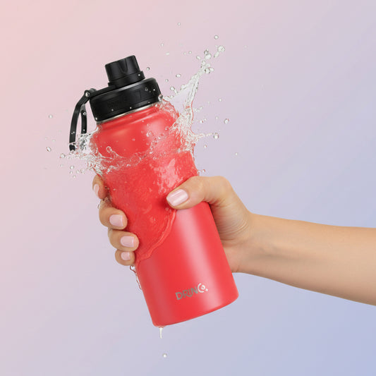 Hand holding red stainless steel water bottle 32oz with insulated design and leak-proof lid for daily hydration