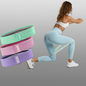 Woman performing leg workout using resistance bands with set of colorful fitness bands for glutes training