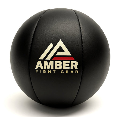 Black leather medicine ball with amber logo – ideal for soft impact training and rehabilitation