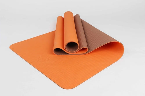 Orange eco mat half-rolled – flexible and soft for gentle fitness routines