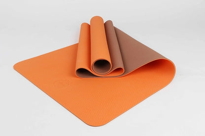Orange eco mat half-rolled – flexible and soft for gentle fitness routines