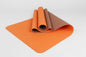 Orange eco mat half-rolled – flexible and soft for gentle fitness routines