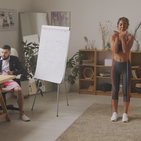 Rear view of resistance band walk outdoors – low-impact glute activation exercise with long elastic band for mindful strength training